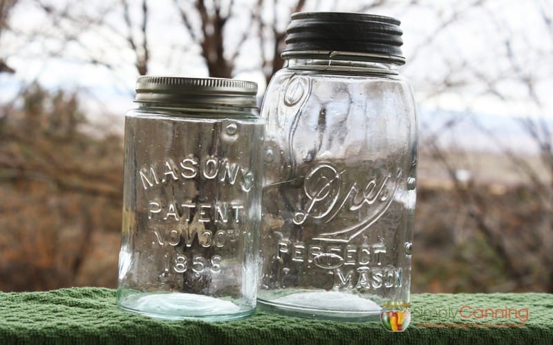 Clear antique canning jars with bubbles in their glass.