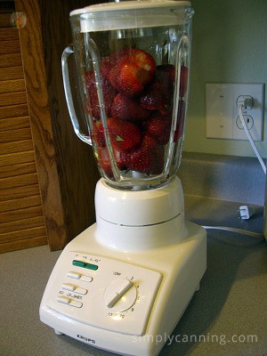 Blending fresh strawberries in the blender.