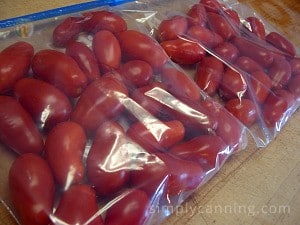 Freezer bags packed with whole unpeeled tomatoes.