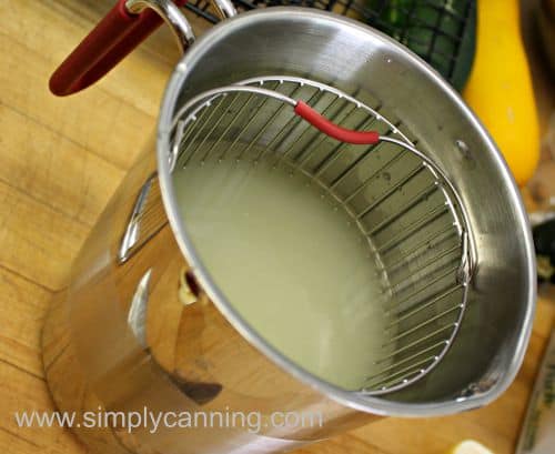Lemon juice mixture shown inside the pot with the basket inside of it.