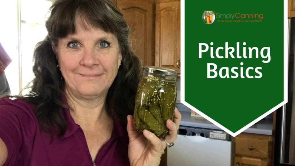 Sharon holding a jar of cucumber pickles.