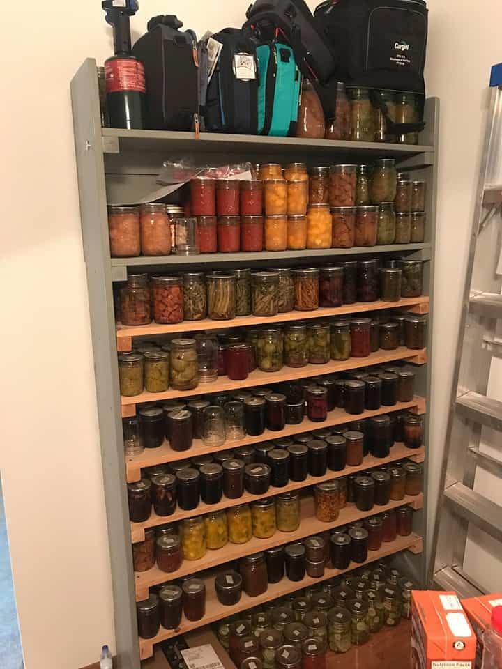 Jars and jars of food packed tightly into a shelf.