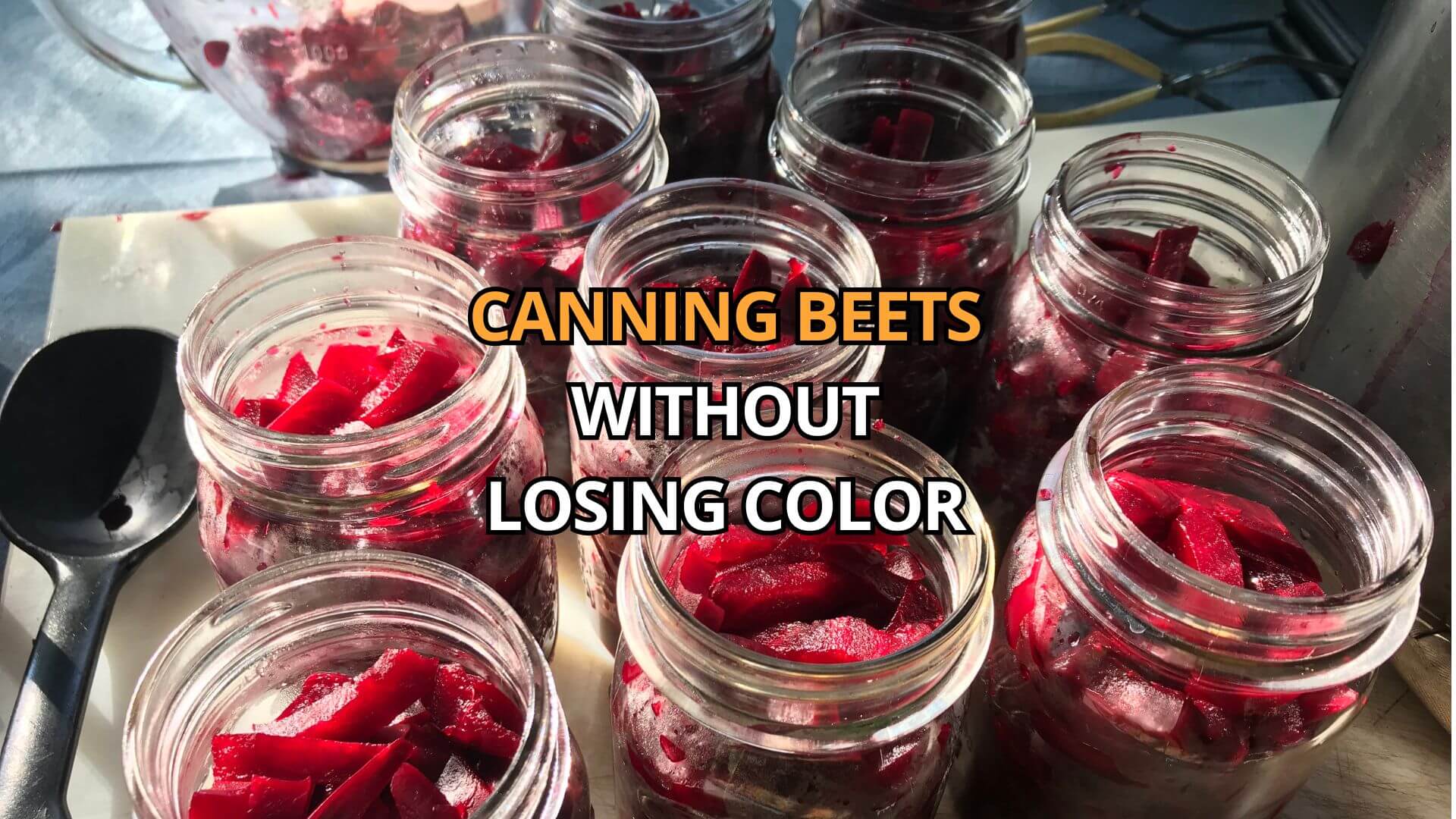 Filling large canning jars with peeled and sliced red beets.