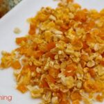 Dried corn kernels on a white plate.