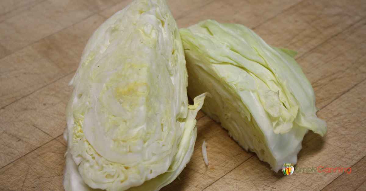 Wedges of fresh, raw cabbage on a wooden cutting board.