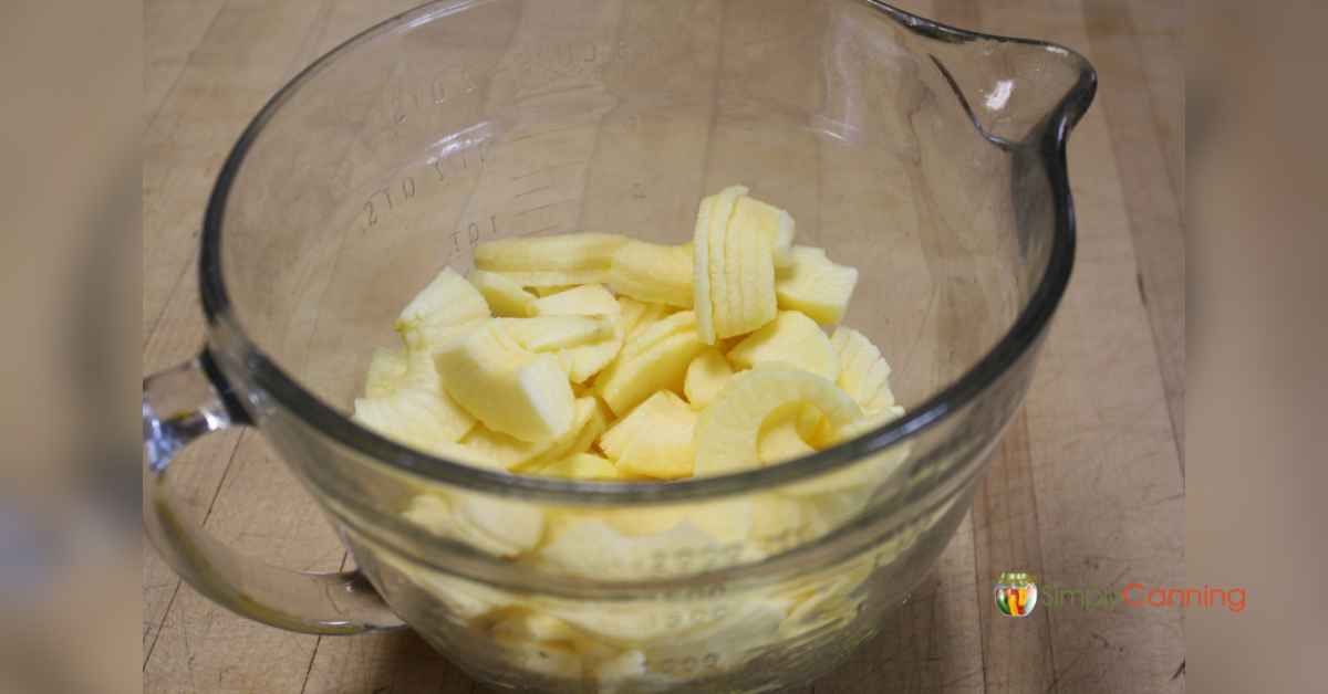 A bowl full of thinly sliced peeled apples for drying.