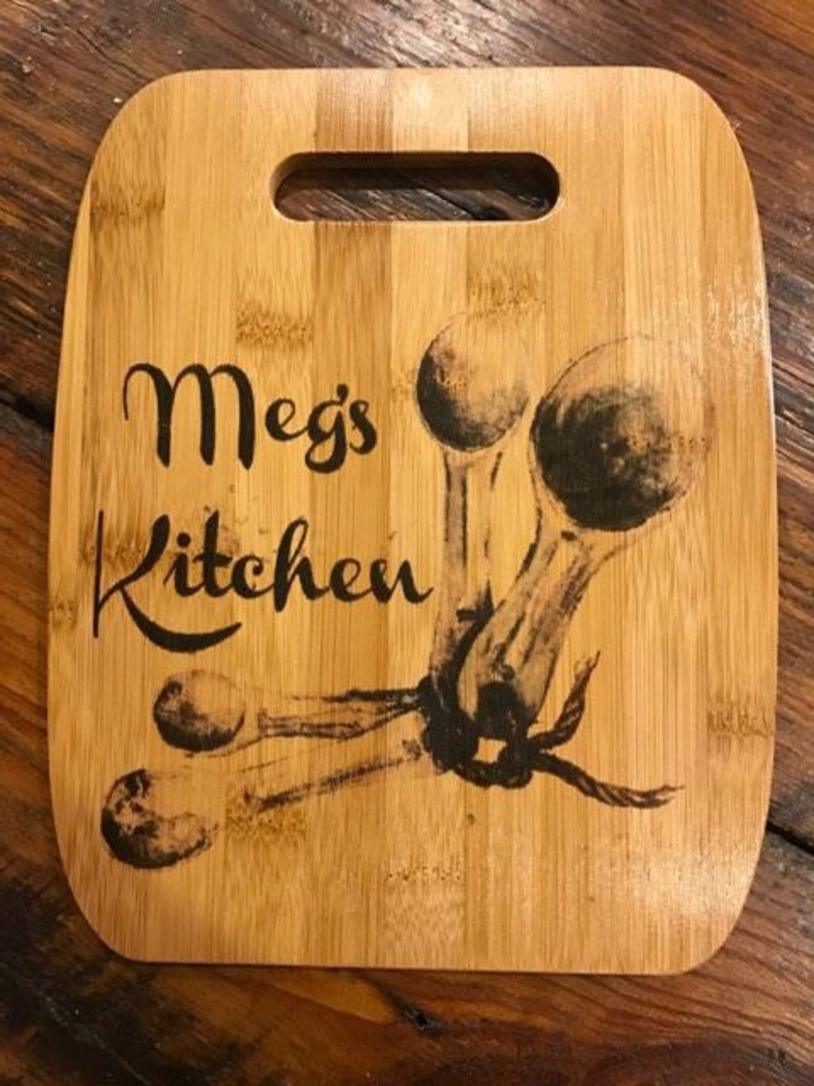 Meg's kitchen cutting board with utensils on it.