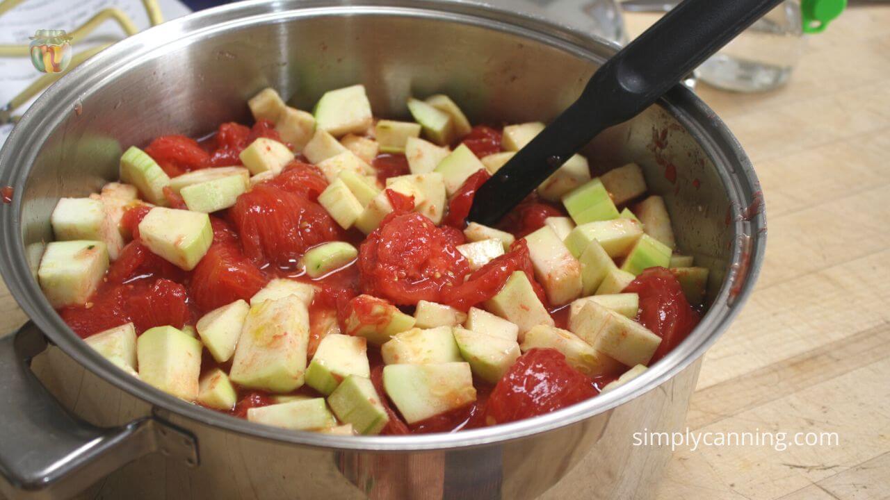 Pot with mixture of zucchini and tomatoes ready to be cooked.
