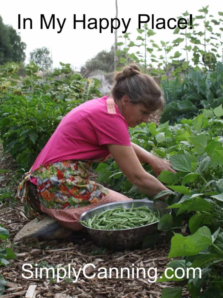 Sharon in the garden picking green beans in her happy place.