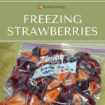 Sliced strawberries packed into a freezer bag.