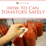 Wiping the rims of tomato jars with a wet paper towel before placing on the lids.