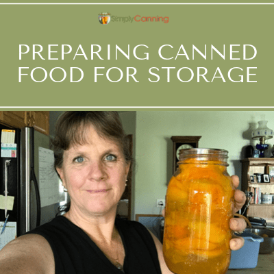 Sharon holding a jar of canned fruit.