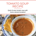 A bowl of creamy tomato soup with cheese and toast on the side.