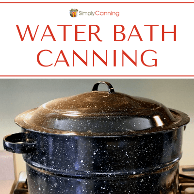 A graniteware water bath canner sitting on a stovetop.