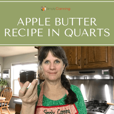 Sharon holding a tiny jar of canned apple butter.