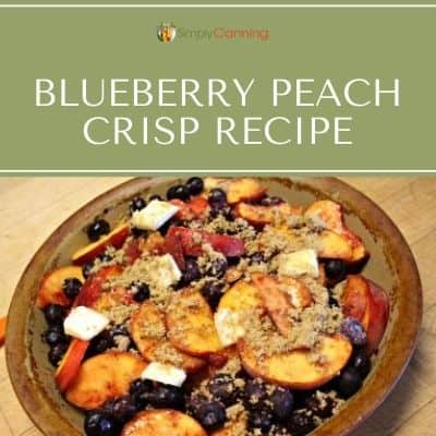 Blueberries and peach slices placed in a pie plate and dotted with pats of butter.