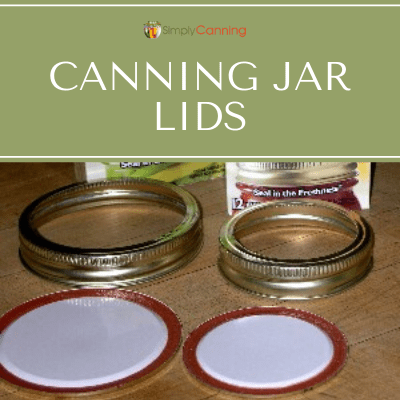 Canning jar lids and rings next to boxes. 