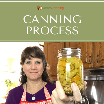 Sharon holding a jar of canned or pickled peppers.