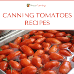 Roma tomatoes floating in a sink full of water.