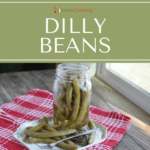 An open jar of dilly beans with a serving on the plate beside of the jar.