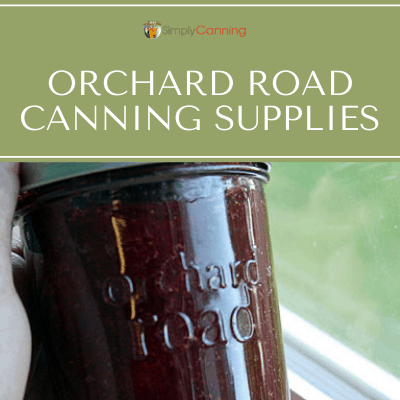 Sharon holding a full Orchard Road canning jar.