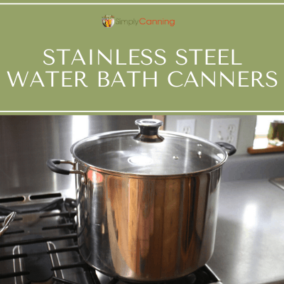 Stainless steel water bath canner with glass lid.