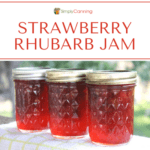 Three bright red jars of strawberry rhubarb jam.