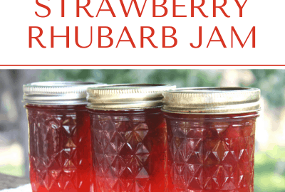 Three bright red jars of strawberry rhubarb jam.