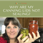 Sharon holding jars of pickles and another home canned product.