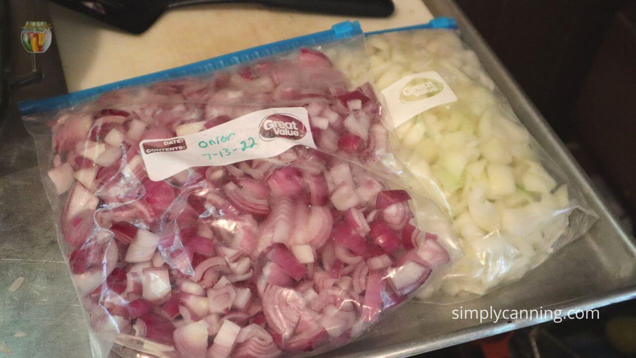 Two quart freezer bags of chopped frozen onions, one with red onion, the other white onion. 