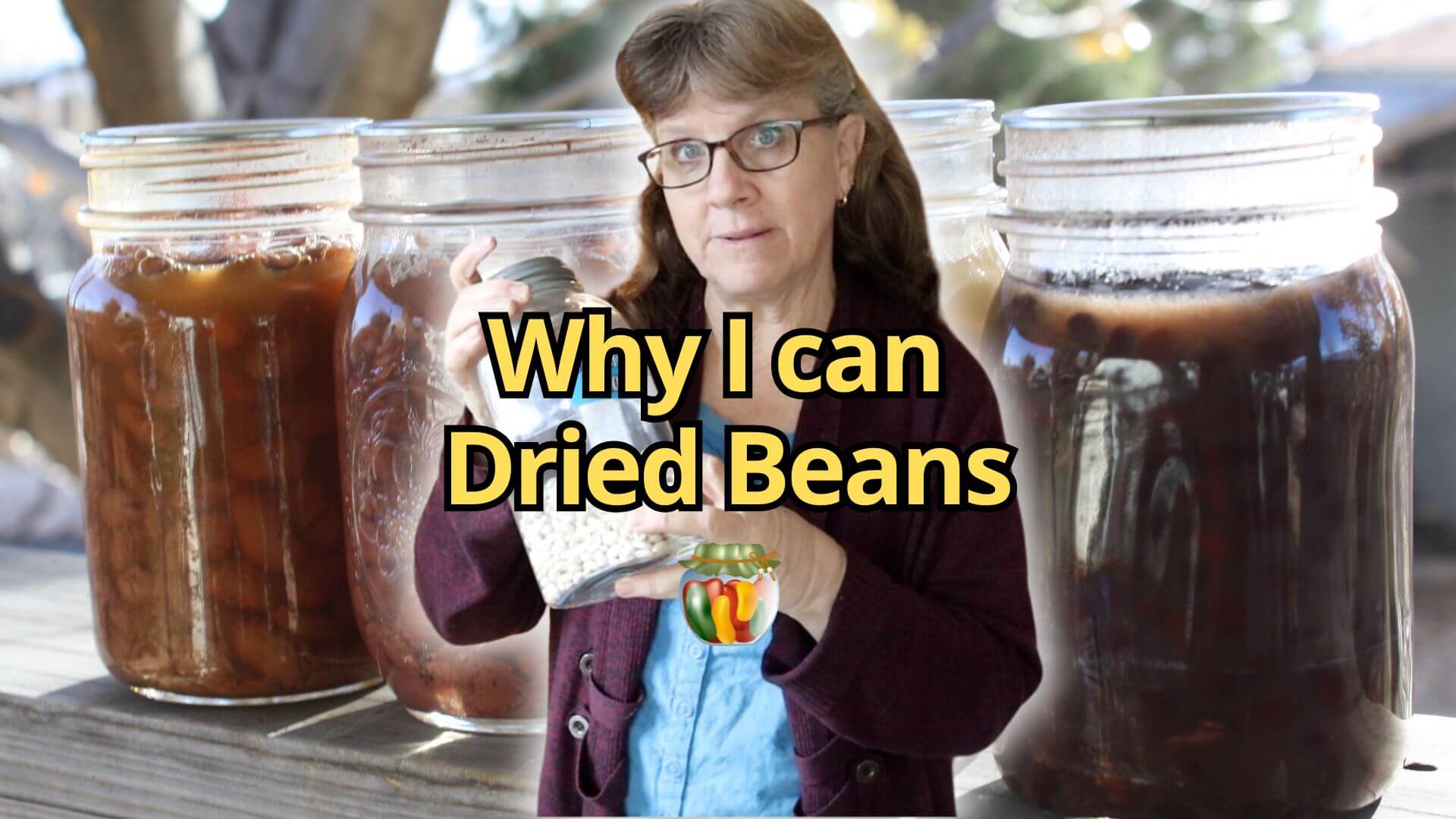 Sharon holding a jar of dried beans with canned beans behind her.