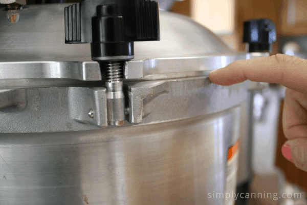 Pointing to the metal to metal seal on the lid of the All American canner.