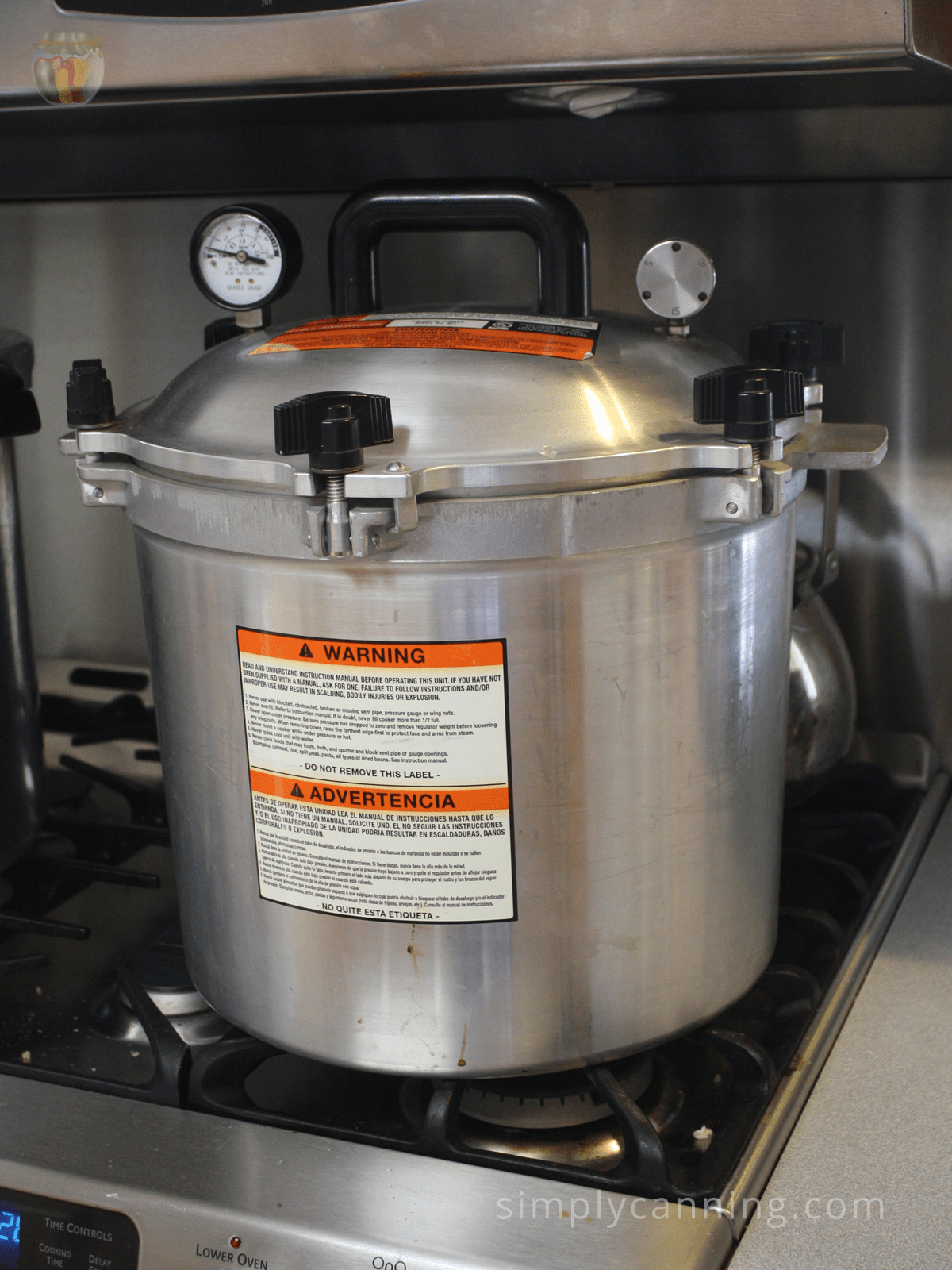 The large All American canner sitting on Sharon's stovetop.