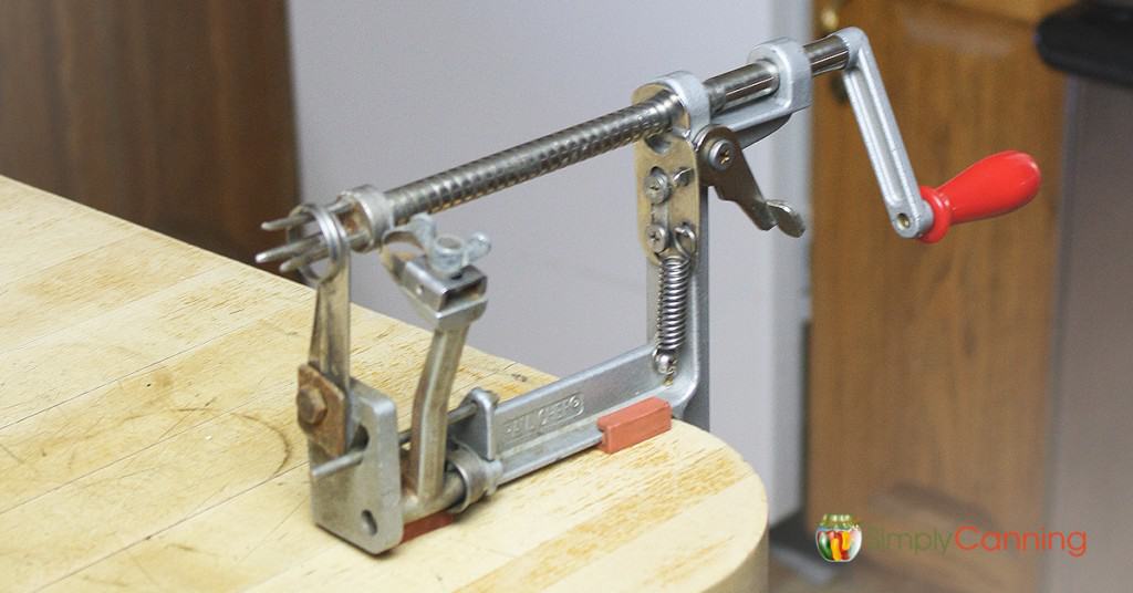 Empty apple peeler corer slicer tool attached to the countertop and waiting to process apples.