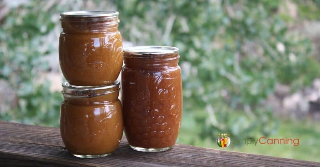 Three jars filled with homemade apricot butter.