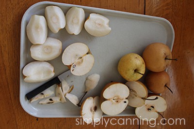 Coring and slicing Asian pears on a board.