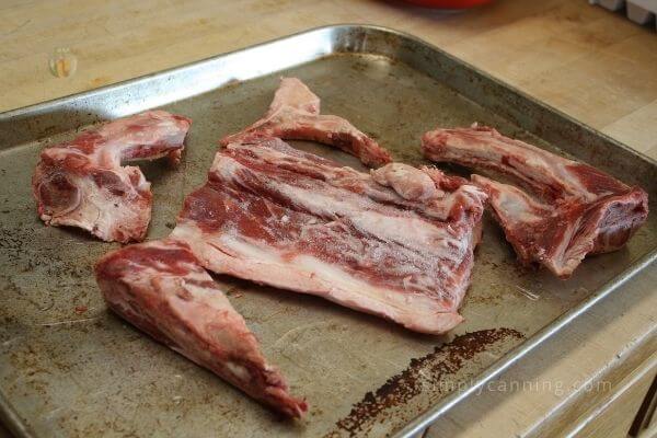 Uncooked beef sitting on a cookie sheet.