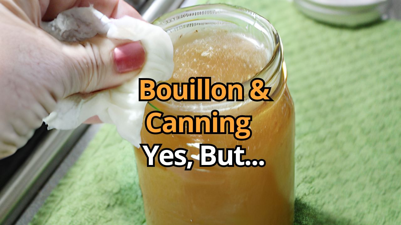 Mason jar of chicken broth with the lid being wiped clean with a paper towel.