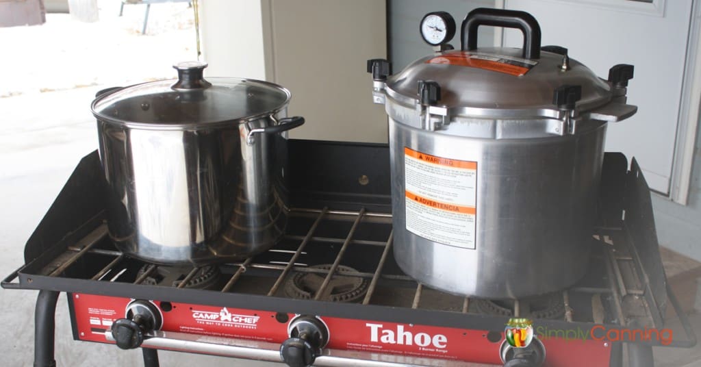 Water bath and pressure canners sitting on the top of the Camp Chef stove.