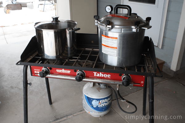 Camp Chef Stove with water bath and pressure canners on top.