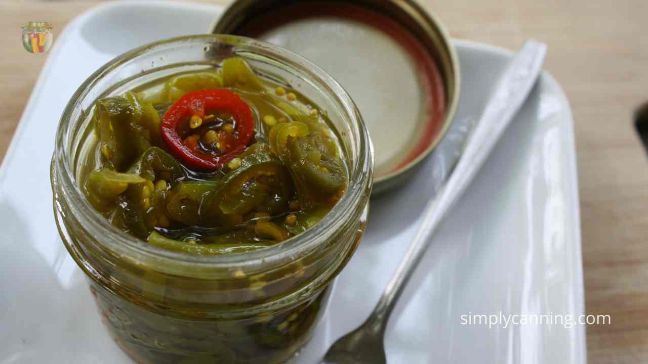 Small open jar of sweet peppers on a white plate.