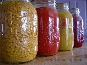 Canned vegetables including canned corn and canned tomatoes in jars.