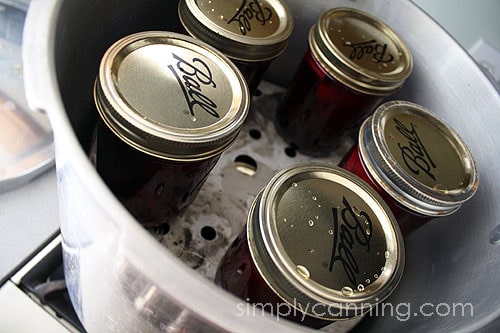 A second layer of canning jars placed on top of the rack in the pressure canner.
