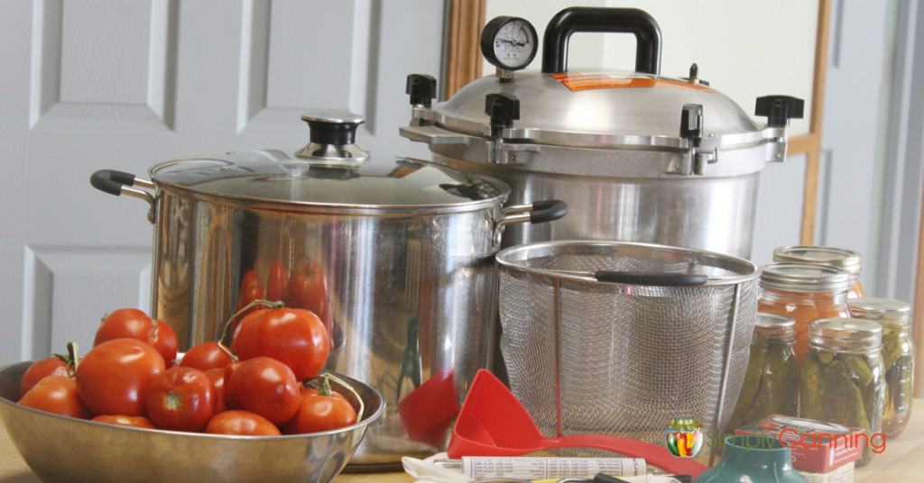 Canners and canning equipment spread over the countertop.