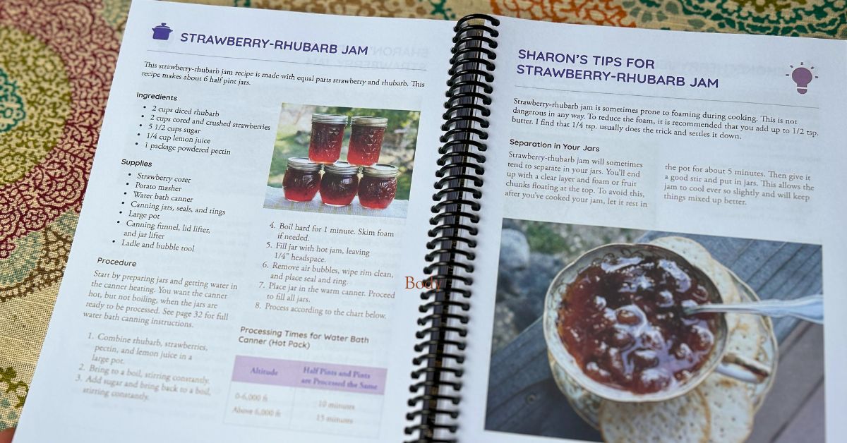 Canning Guide book opened to strawberry rhurbarb jam page with sharons tips. 