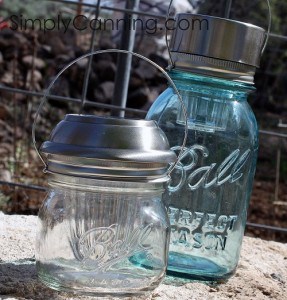 Mason jar solar lights in blue and clear glass designs.