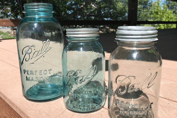 Three canning jars of various colors and shapes.