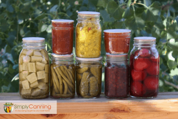 Stacks of jars filled with home canned food of various colors.