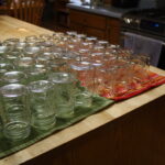 Empty canning jars drying on a counter.