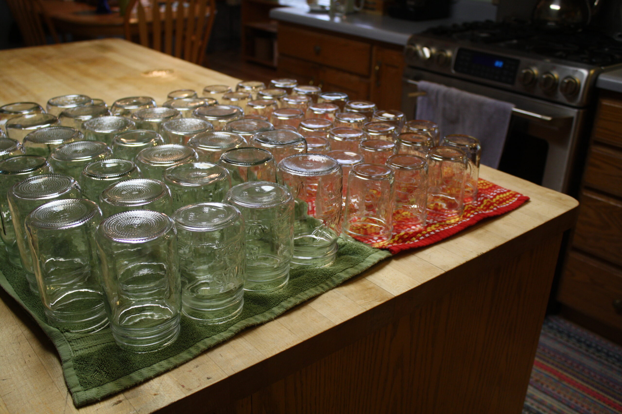 Empty canning jars drying on a counter.  